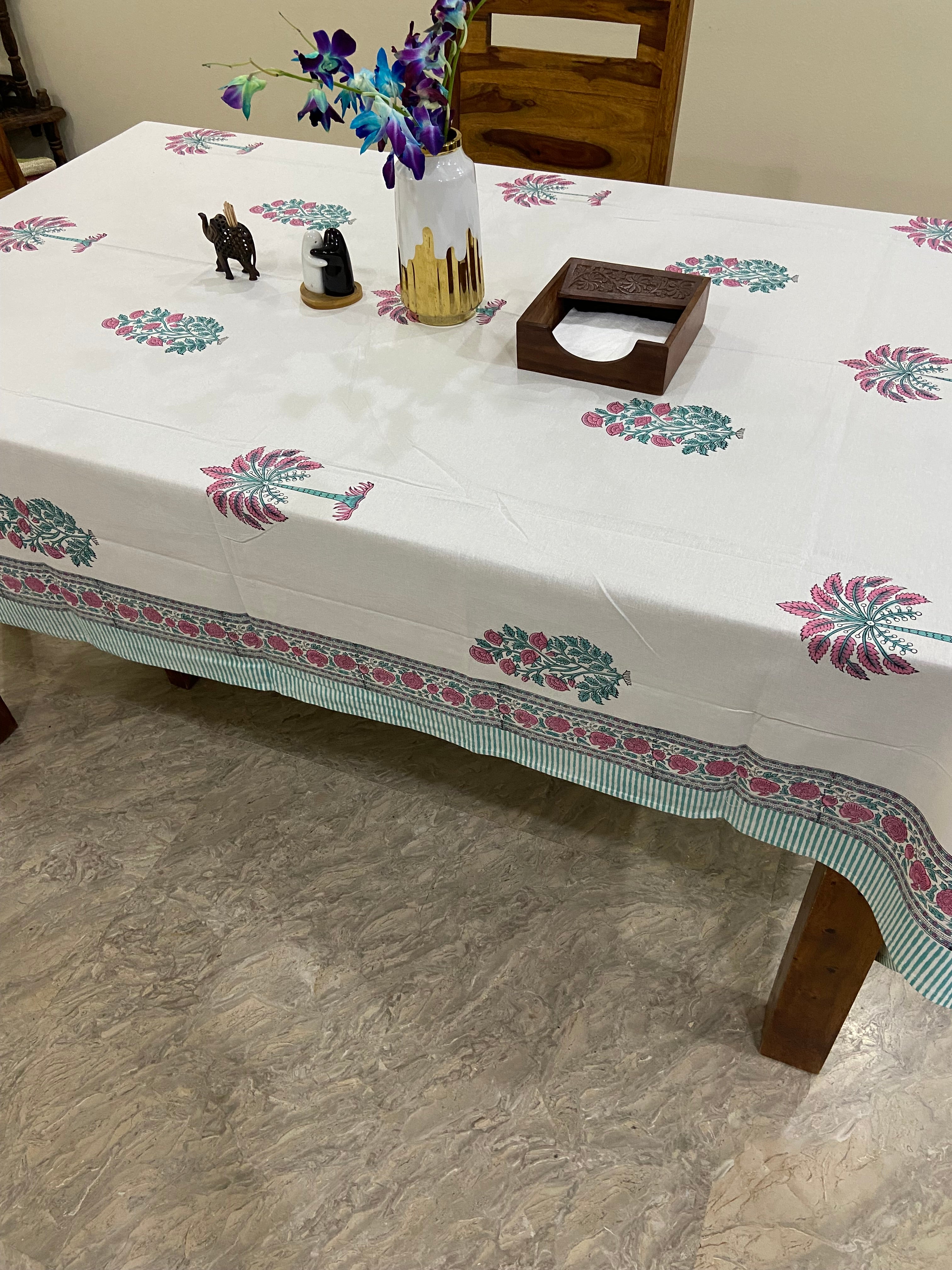 Table with a floral-patterned tablecloth on a stone floor